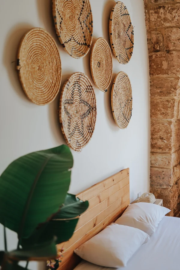 18 Above Bed Decor Ideas to Make Your Bedroom Feel Cozy and Stylish 6 Hang Woven Baskets in a Loose Cluster