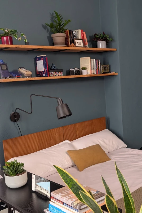 18 Above Bed Decor Ideas to Make Your Bedroom Feel Cozy and Stylish 8 Mount Two Floating Shelves for Books and Plants