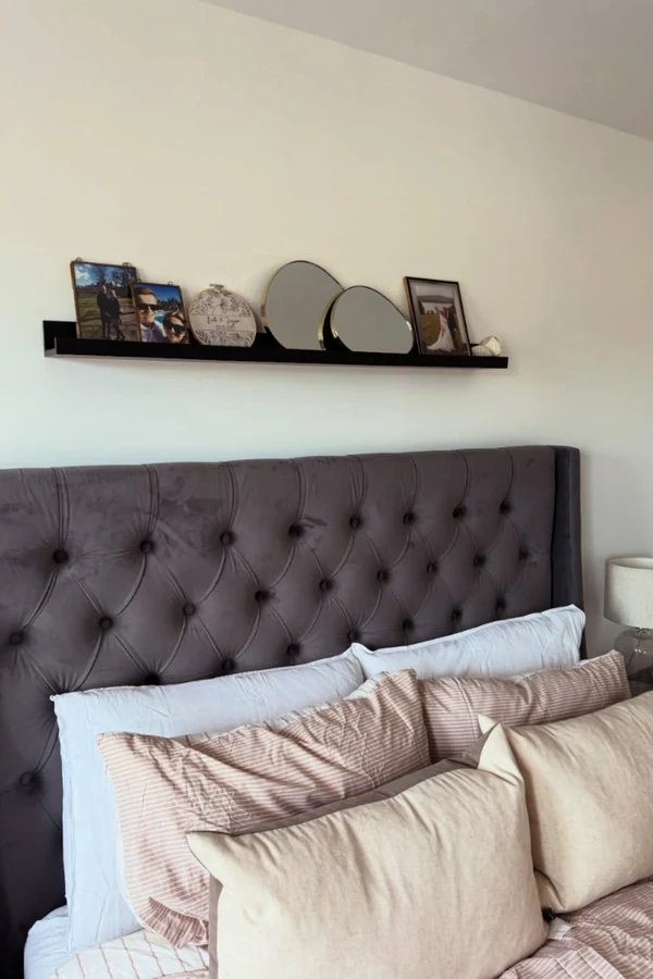 18 Above Bed Decor Ideas to Make Your Bedroom Feel Cozy and Stylish 11 Set a Long Picture Ledge for Layered Frames