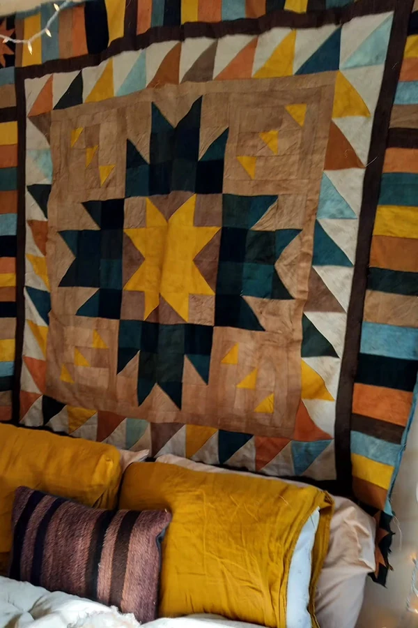 18 Above Bed Decor Ideas to Make Your Bedroom Feel Cozy and Stylish 16 Hang a Favorite Quilt or Textile as Art