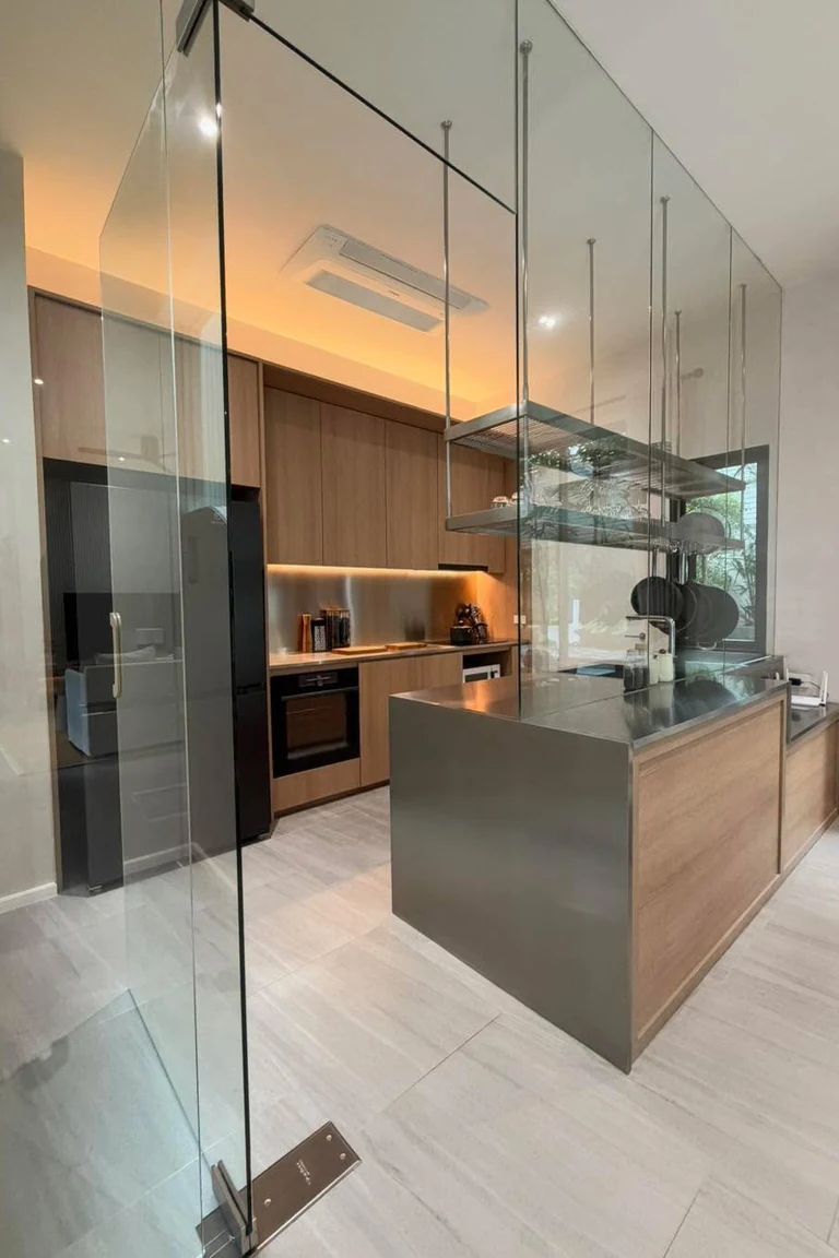 18 Small Kitchen Partition Ideas 2 Compact kitchen enclosed by frameless glass panels with a steel island and wood cabinets