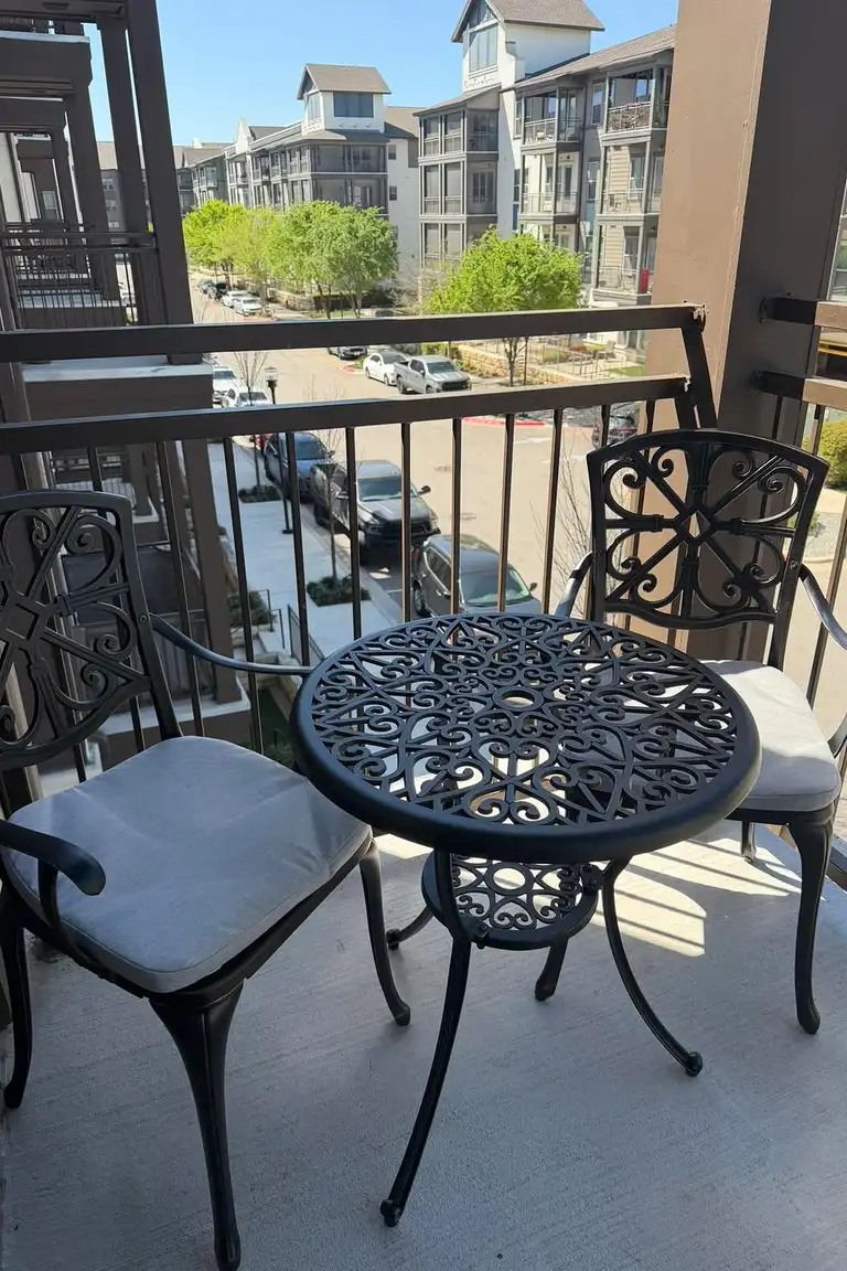 Compact bistro set with two chairs and a small table on a small apartment balcony