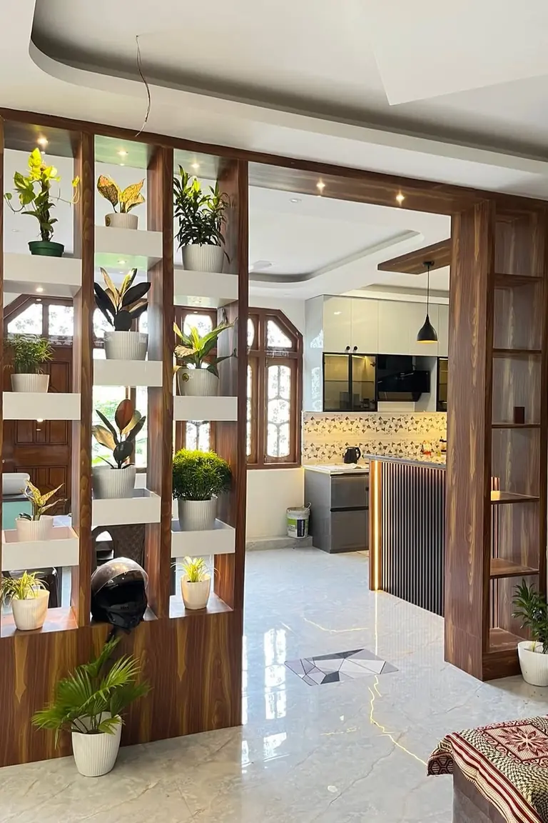 18 Small Kitchen Partition Ideas 4 Tall wood open shelving divider with potted plants between a living area and a kitchen