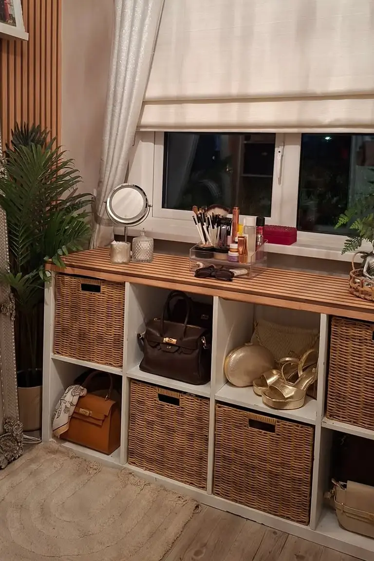 Stunning Kallax Bedroom Transformations You Need to See 6 A white cube shelf with wicker baskets, handbags, and shoes under a window, topped with a small round vanity mirror, makeup brushes, and perfume bottles in a dressing corner