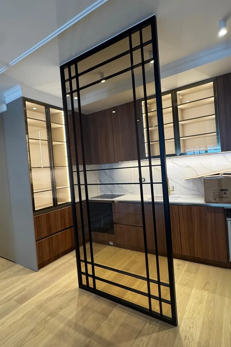 18 Small Kitchen Partition Ideas 7 Black metal framed glass grid partition in front of a wood kitchen