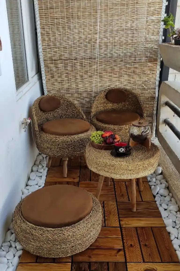 Small apartment patio with a freestanding privacy screen and tall plants
