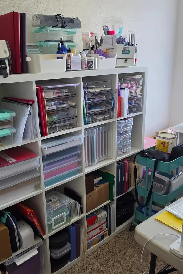 Stunning Kallax Bedroom Transformations You Need to See 10 A bright craft room with a tall white 16-cube Kallax filled with clear drawer organizers, binders and supplies, beside a work table with a lamp
