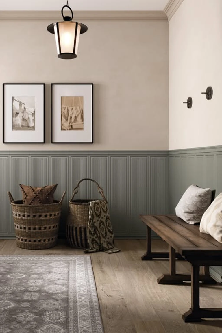 Entryway with sage green ribbed wainscoting, cream upper walls and a wooden bench