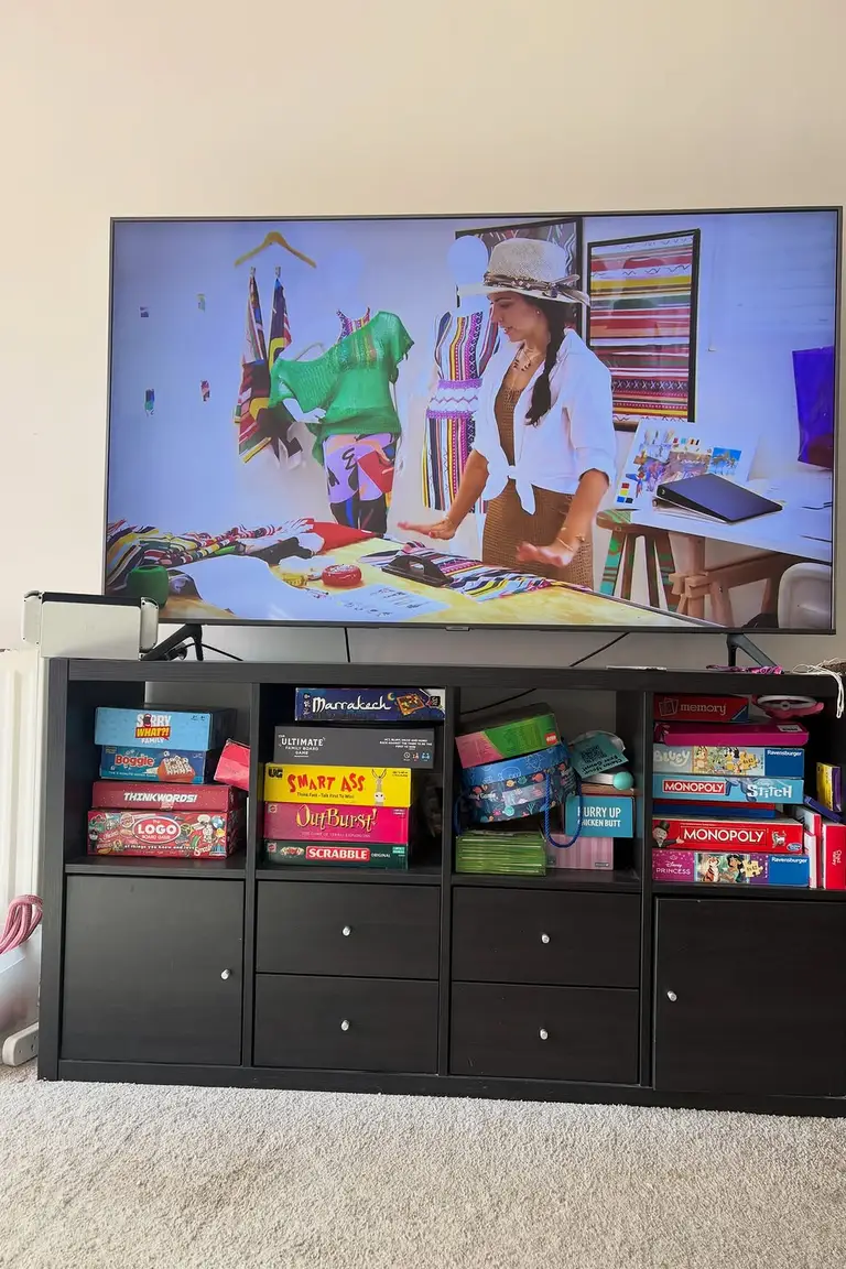 Stunning Kallax Bedroom Transformations You Need to See 11 A large flat-screen television on a black cube storage unit filled with board games, in a living room with beige carpet