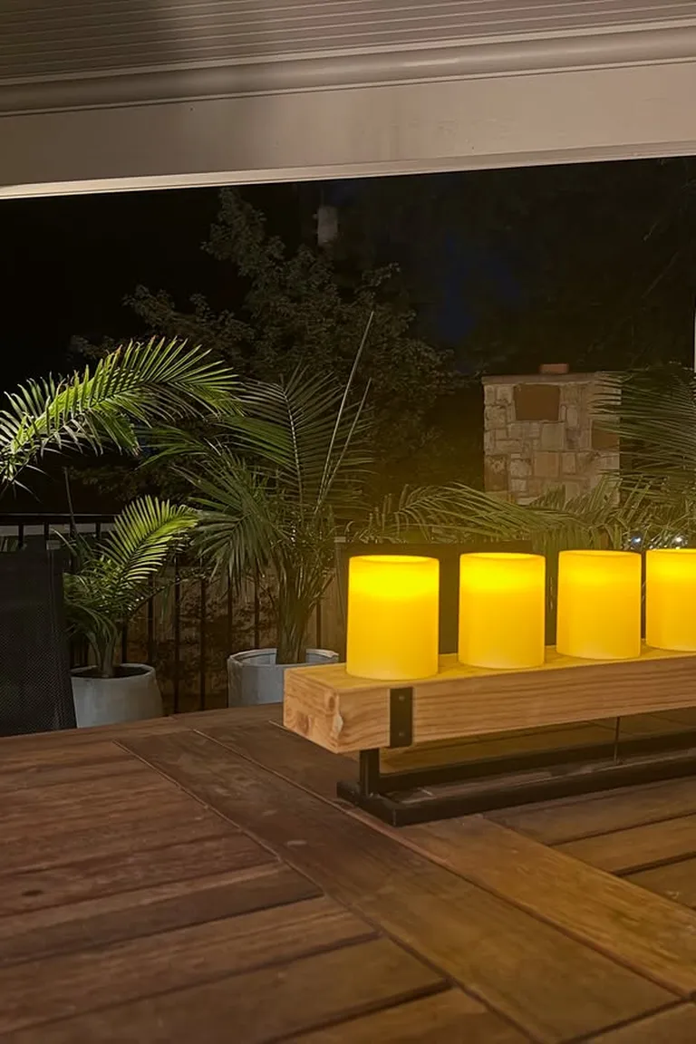 Small patio in the evening lit by glowing candles on the table