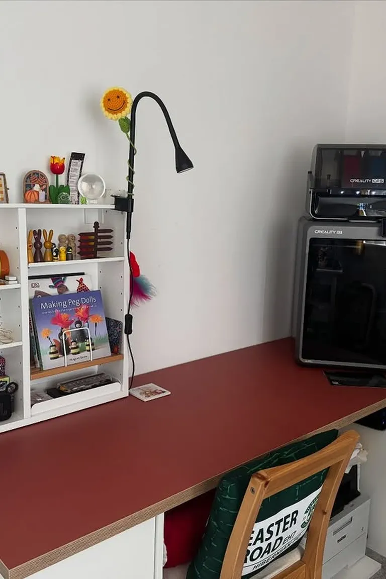Stunning Kallax Bedroom Transformations You Need to See 14 A home craft desk with a red worktop, wall-mounted white cube shelves holding supplies above it, and a 3D printer on the desk