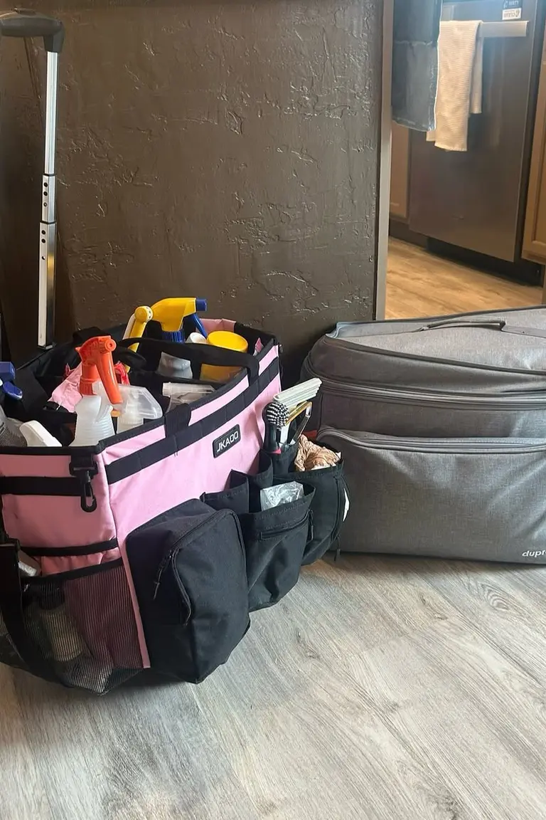 Handled rolling caddy packed with spray bottles and cleaning brushes