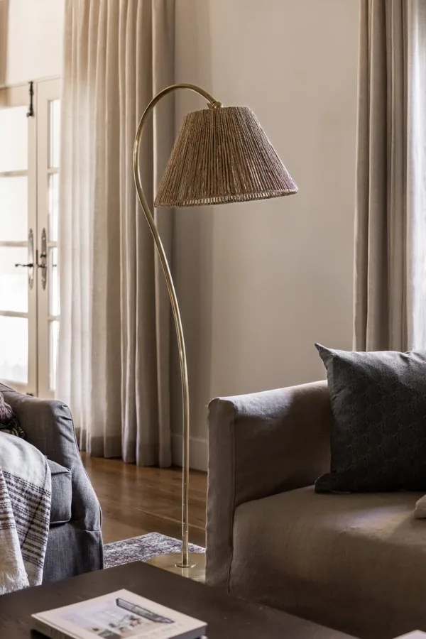 17 Empty Corner Living Room Ideas to Make Your Space Feel Complete 3 Fill a Dark Corner With a Tall Arc Floor Lamp Over the Sofa End