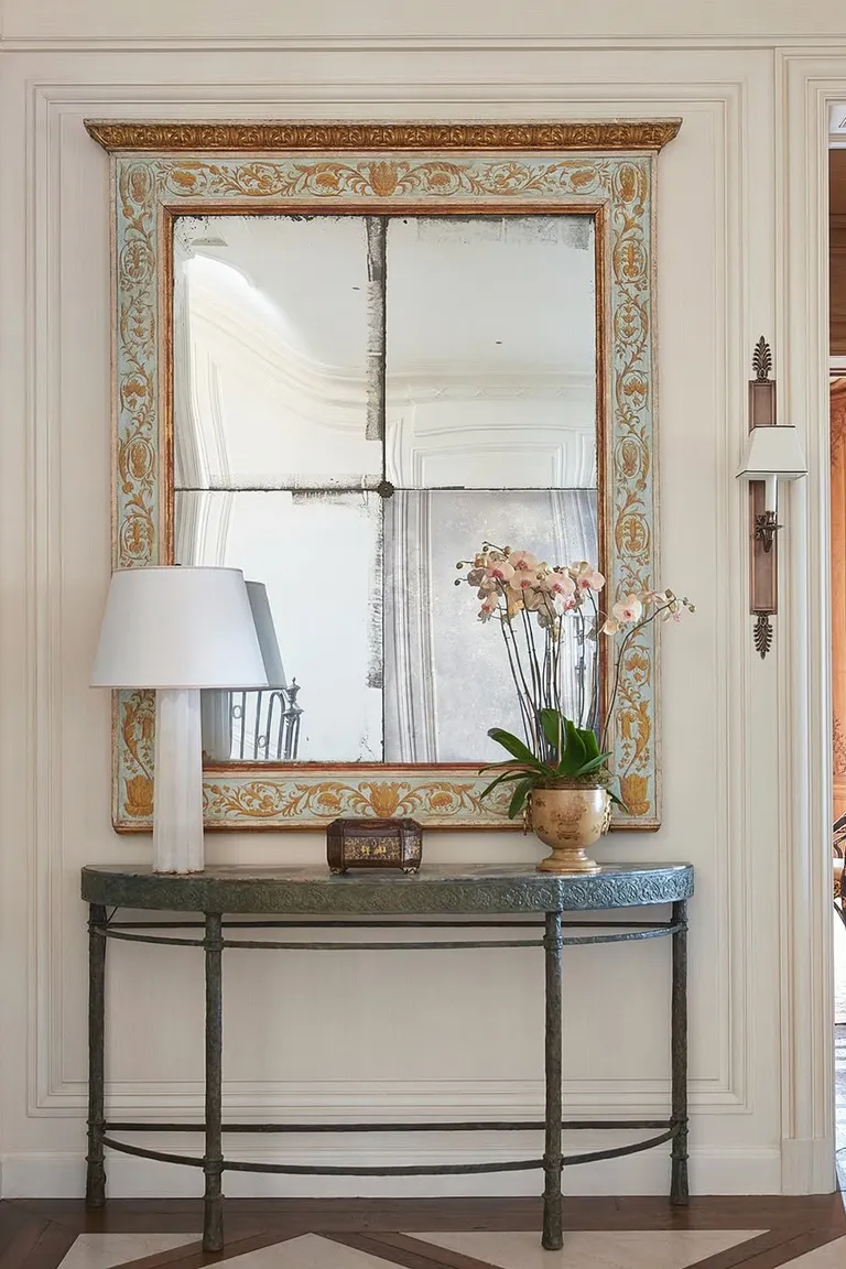 25 Stunning Accent Wall Ideas for Every Room and Style 23 Entryway with a large antique four-pane mirror with foxing in an ornate frame above a narrow console table with a lamp and an orchid