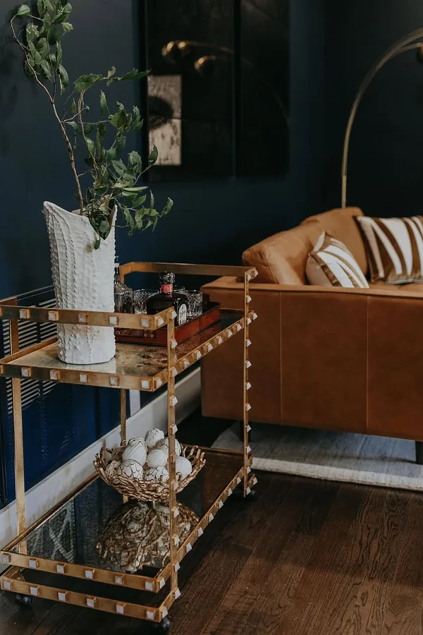 17 Empty Corner Living Room Ideas to Make Your Space Feel Complete 7 Roll in a Two Tier Bar Cart for Drinks Near the Seating Area