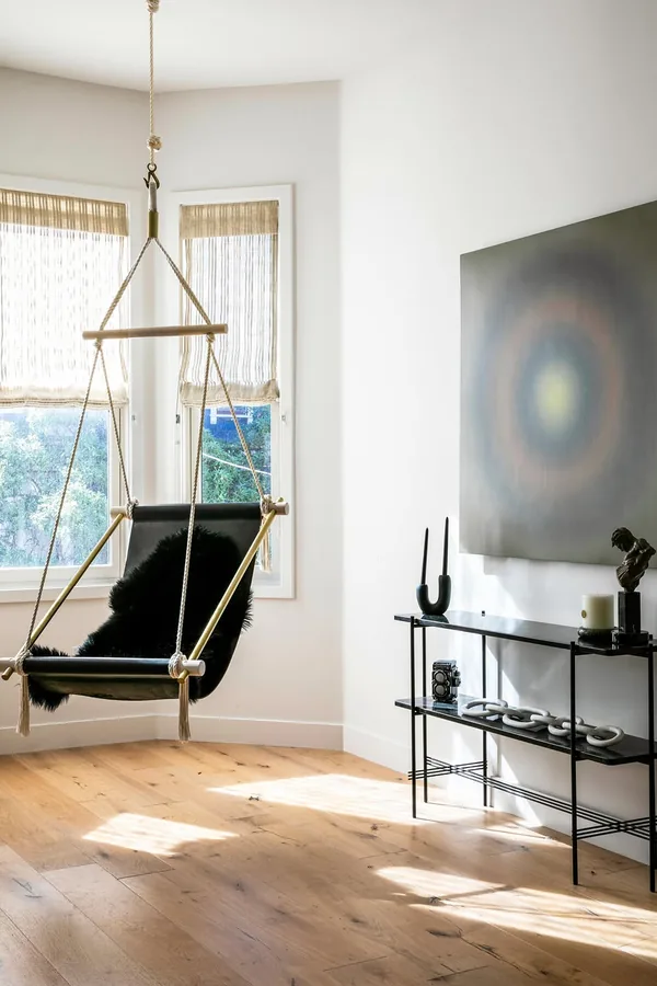 17 Empty Corner Living Room Ideas to Make Your Space Feel Complete 14 Hang a Corner Swing Chair in a Wide Corner With Floor Space to Spare