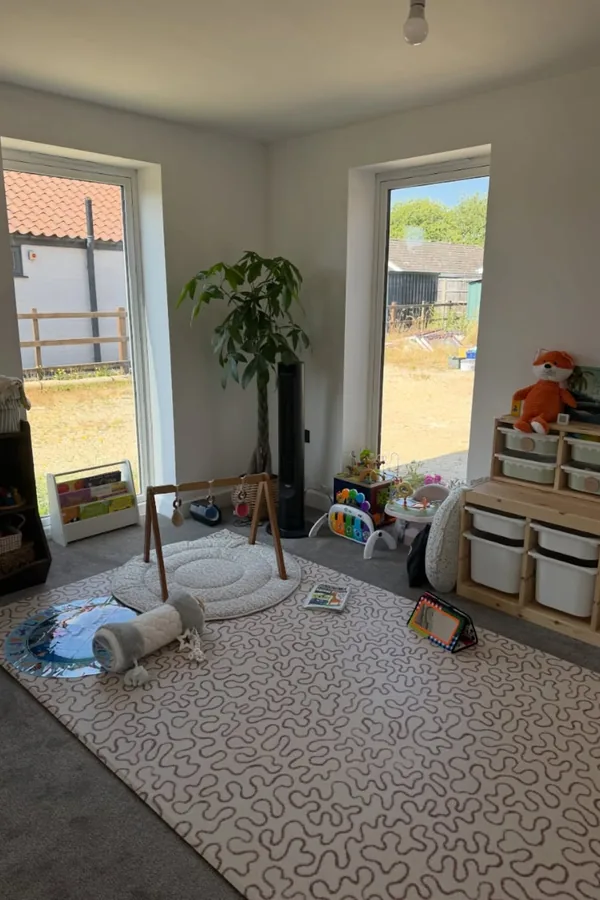 17 Empty Corner Living Room Ideas to Make Your Space Feel Complete 16 Set Up a Kids Play Corner With a Low Book Bin and a Small Rug